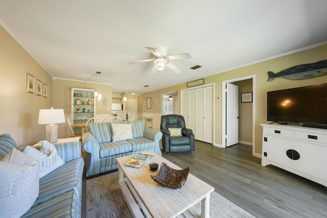 3755 Scenic Highway 98 Unit 1601, Destin, FL 32541 - living room with dark wood finished floors, ceiling fan, crown molding, a textured ceiling, and baseboards