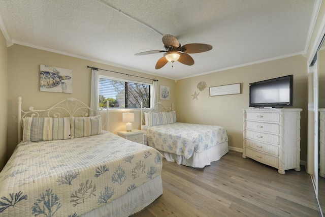 3755 Scenic Highway 98 Unit 1601, Destin, FL 32541 - bedroom with wood finished floors, crown molding, ceiling fan, and a textured ceiling