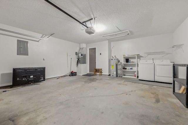 garage featuring washing machine and clothes dryer, electric panel, electric water heater, and a garage door opener