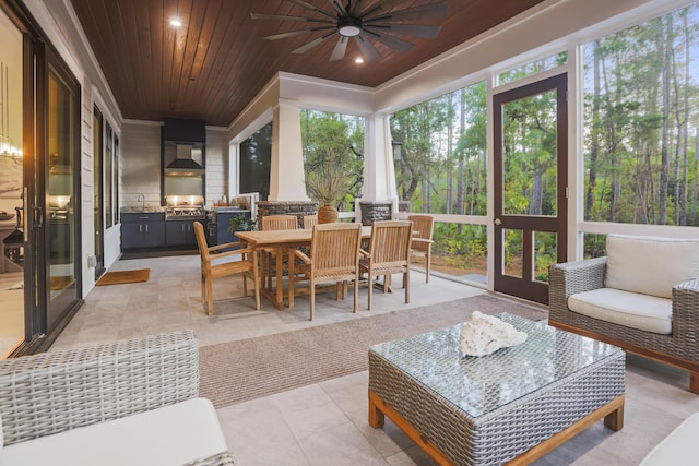 1807 Lost Cove Ct, Panama City Beach, FL 32413 - sunroom with exterior kitchen, a ceiling fan, healthy amount of natural light, and outdoor dining space