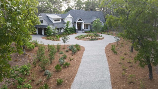 1807 Lost Cove Ct, Panama City Beach, FL 32413 - craftsman house with curved driveway and a garage