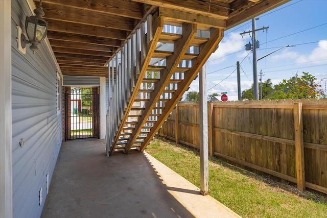 view of patio / terrace with stairway and fence