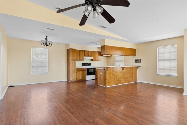 kitchen featuring electric stove, brown cabinetry, open floor plan, light countertops, and lofted ceiling