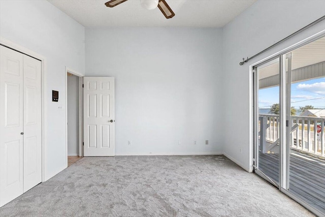 unfurnished bedroom featuring access to outside, carpet, baseboards, and a ceiling fan