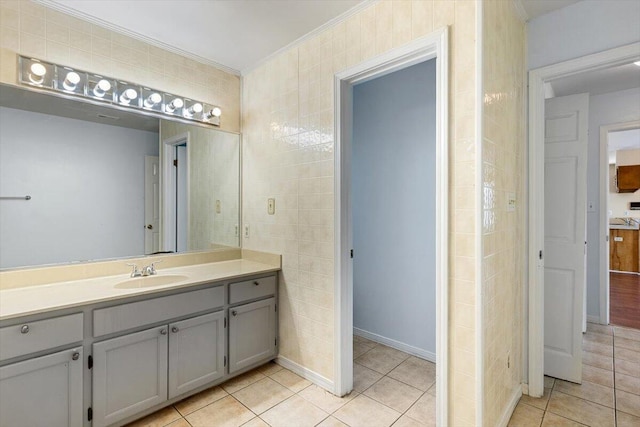 bathroom featuring ornamental molding, tile patterned flooring, and vanity