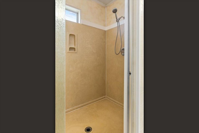 bathroom featuring a stall shower and ornamental molding