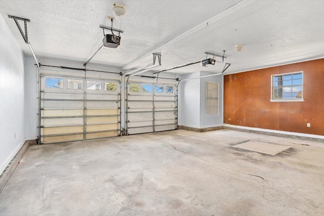 garage with a garage door opener and baseboards