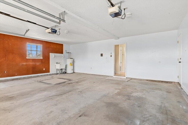 garage with a garage door opener, water heater, and a sink