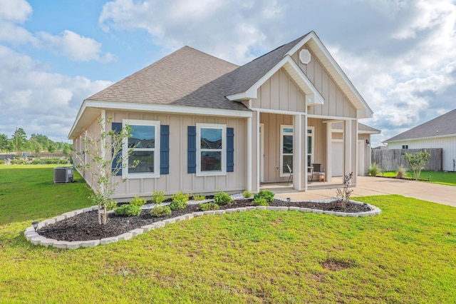 602 Champ Trl, Crestview, FL 32539 - view of front facade featuring board and batten siding, central AC, a shingled roof, a garage, and concrete driveway