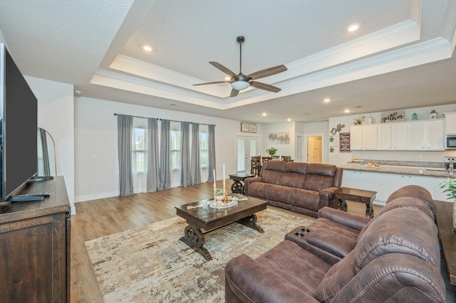 602 Champ Trl, Crestview, FL 32539 - living area featuring a raised ceiling, ceiling fan, light wood finished floors, and recessed lighting