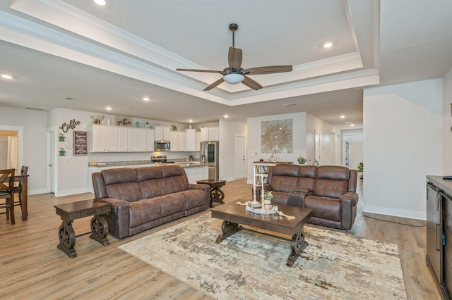602 Champ Trl, Crestview, FL 32539 - living area featuring a raised ceiling, baseboards, a ceiling fan, light wood-style flooring, and recessed lighting