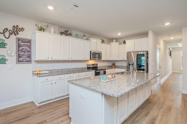 602 Champ Trl, Crestview, FL 32539 - kitchen with appliances with stainless steel finishes, a sink, light wood-style flooring, white cabinets, and recessed lighting