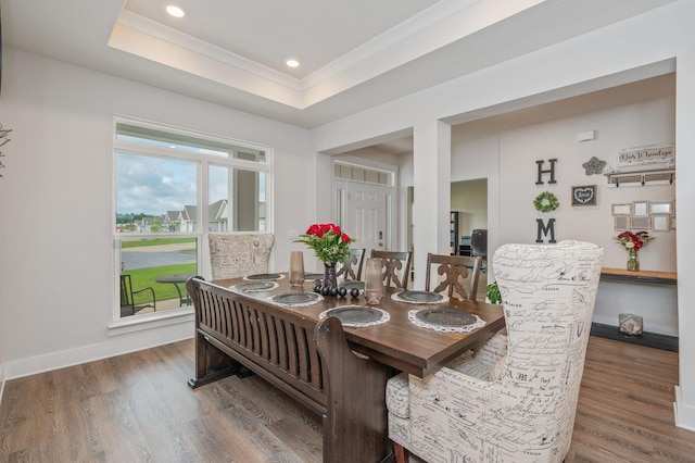 602 Champ Trl, Crestview, FL 32539 - dining area with wood finished floors, ornamental molding, recessed lighting, a tray ceiling, and baseboards