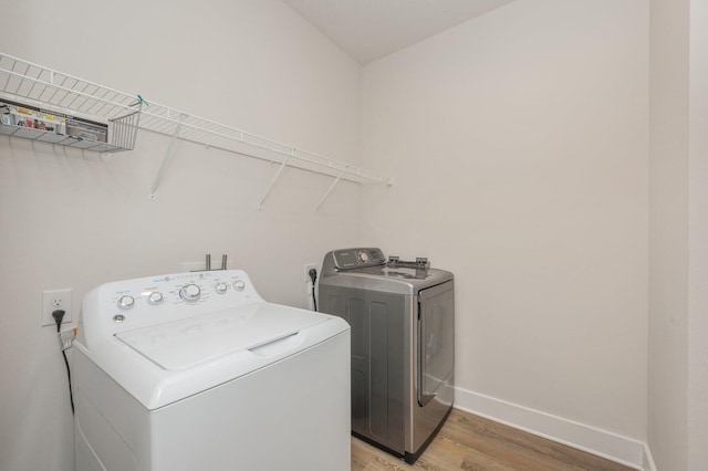 602 Champ Trl, Crestview, FL 32539 - laundry area featuring independent washer and dryer, light wood finished floors, and baseboards