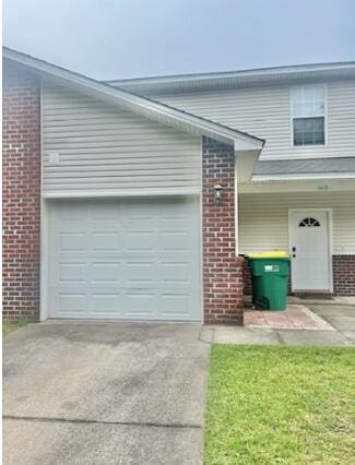 1413 Beaver Run Rd Unit 7, Niceville, FL 32578 - view of side of home with brick siding, concrete driveway, and an attached garage