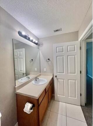 1413 Beaver Run Rd Unit 7, Niceville, FL 32578 - half bath with vanity, tile patterned floors, and a textured ceiling