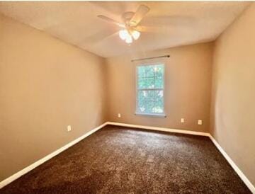 1413 Beaver Run Rd Unit 7, Niceville, FL 32578 - unfurnished room with baseboards, a ceiling fan, and dark carpet