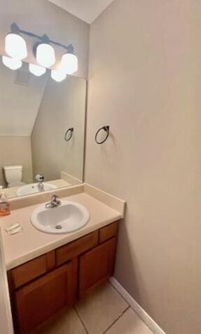 1413 Beaver Run Rd Unit 7, Niceville, FL 32578 - bathroom featuring vanity, tile patterned floors, lofted ceiling, baseboards, and toilet