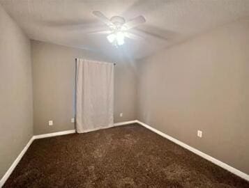 1413 Beaver Run Rd Unit 7, Niceville, FL 32578 - spare room featuring a ceiling fan, dark carpet, and baseboards
