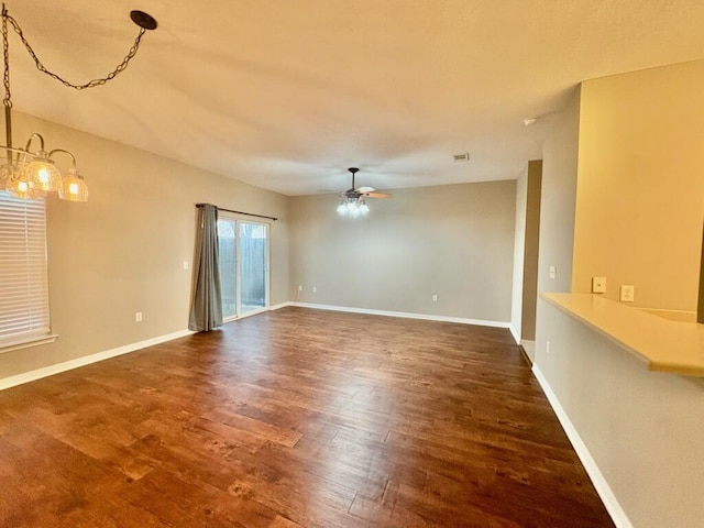 1413 Beaver Run Rd Unit 7, Niceville, FL 32578 - empty room featuring ceiling fan, dark wood finished floors, and a chandelier