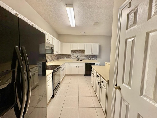 1413 Beaver Run Rd Unit 7, Niceville, FL 32578 - kitchen featuring black appliances, a textured ceiling, light countertops, tasteful backsplash, and light tile patterned flooring