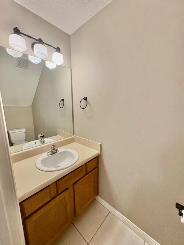 1413 Beaver Run Rd Unit 7, Niceville, FL 32578 - half bathroom with vanity, tile patterned floors, and a textured ceiling
