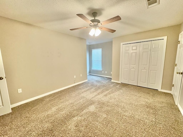 1413 Beaver Run Rd Unit 7, Niceville, FL 32578 - unfurnished bedroom with carpet, a textured ceiling, ceiling fan, and a closet