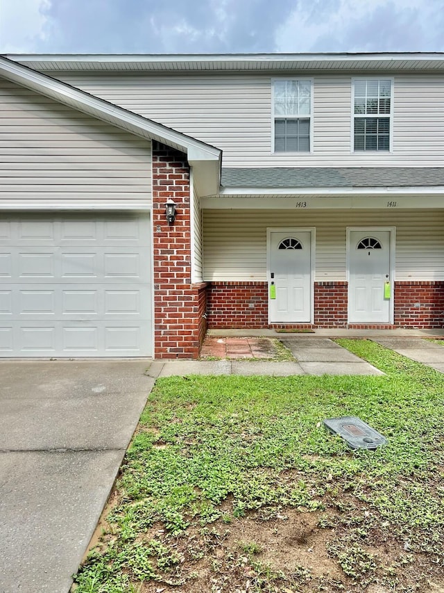 1413 Beaver Run Rd Unit 7, Niceville, FL 32578 - view of front of property featuring brick siding, concrete driveway, and an attached garage