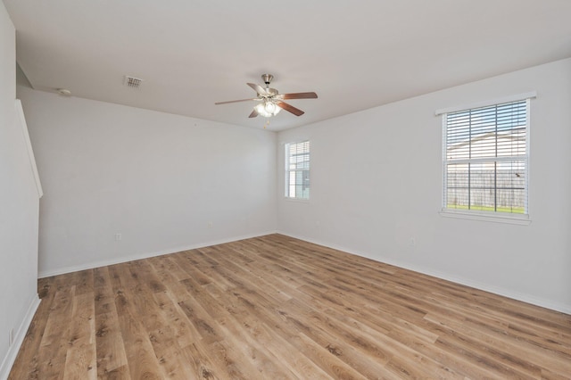 613 Prairie St, Crestview, FL 32536 - spare room with light wood-type flooring, a ceiling fan, and baseboards