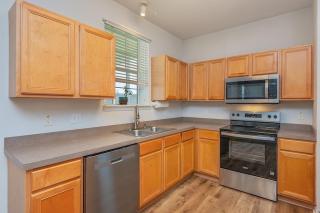 613 Prairie St, Crestview, FL 32536 - kitchen featuring appliances with stainless steel finishes, a sink, light wood-style flooring, and light brown cabinets