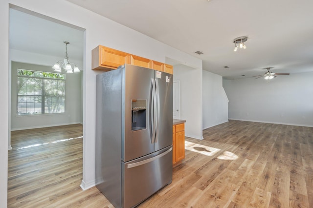 613 Prairie St, Crestview, FL 32536 - kitchen featuring stainless steel refrigerator with ice dispenser, a chandelier, light wood-type flooring, a ceiling fan, and open floor plan