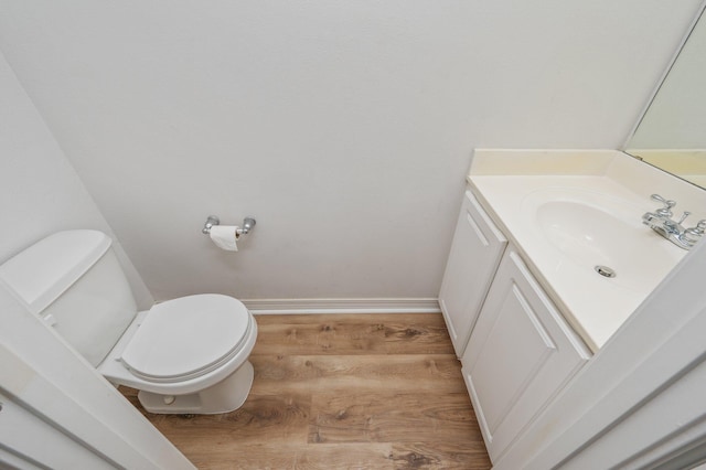 613 Prairie St, Crestview, FL 32536 - bathroom with wood finished floors, toilet, vanity, and baseboards