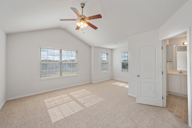 613 Prairie St, Crestview, FL 32536 - unfurnished bedroom with light colored carpet, vaulted ceiling, a sink, baseboards, and ceiling fan