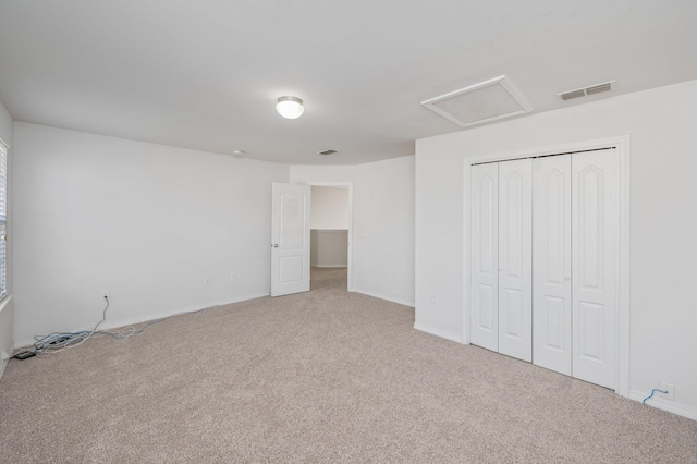 613 Prairie St, Crestview, FL 32536 - unfurnished bedroom featuring attic access, carpet floors, a closet, and baseboards