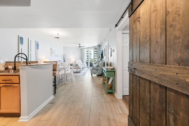 4207 Indian Bayou Trl Unit 2513, Destin, FL 32541 - corridor with a sink, light wood-style floors, and a barn door