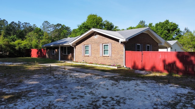 3961 Painter Branch Rd, Crestview, FL 32539 - view of side of property featuring brick siding, fence, and metal roof
