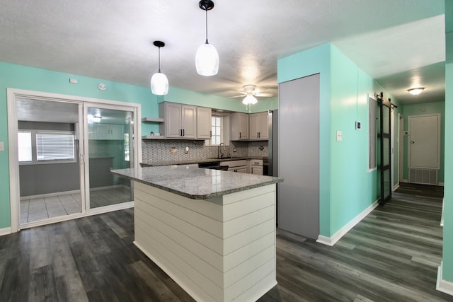 3961 Painter Branch Rd, Crestview, FL 32539 - kitchen featuring baseboards, dark wood finished floors, and a barn door