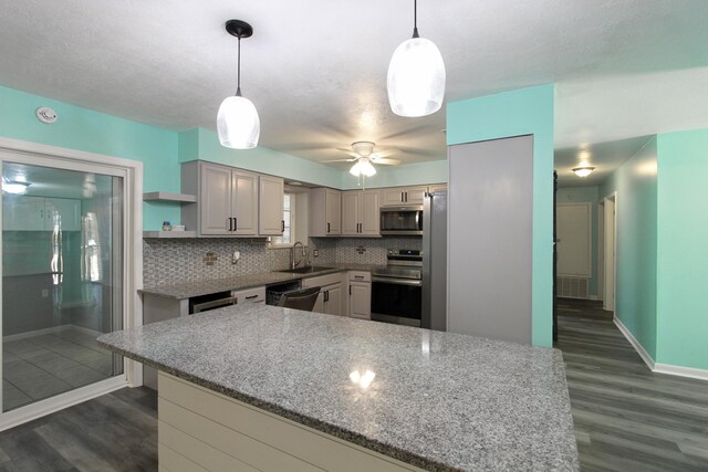 3961 Painter Branch Rd, Crestview, FL 32539 - kitchen featuring stainless steel appliances, a sink, dark wood-style floors, and backsplash