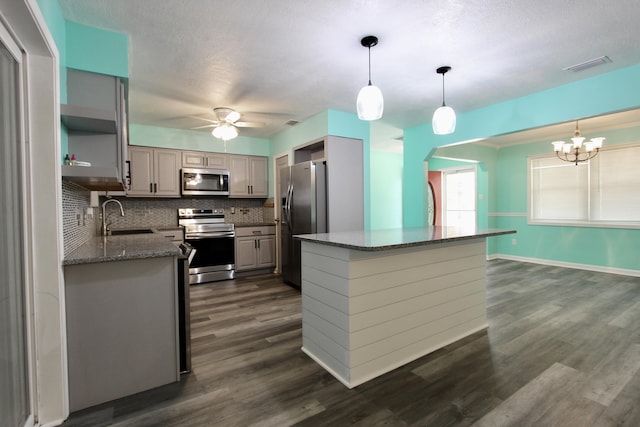 3961 Painter Branch Rd, Crestview, FL 32539 - kitchen featuring stainless steel appliances, a sink, a ceiling fan, backsplash, and a chandelier