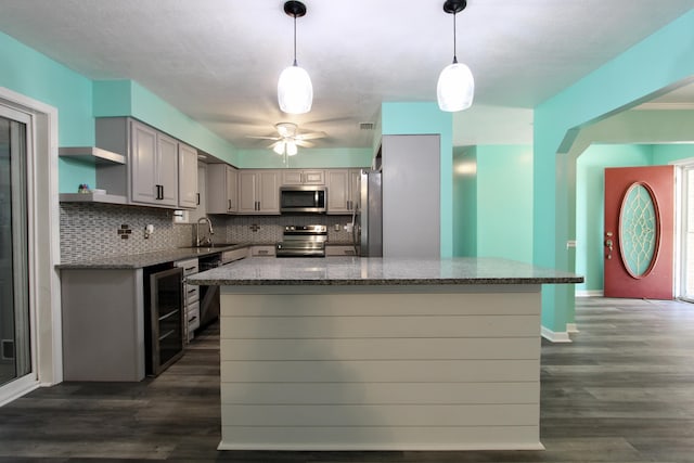 3961 Painter Branch Rd, Crestview, FL 32539 - kitchen featuring stainless steel appliances, wine cooler, tasteful backsplash, a sink, and dark wood-style floors
