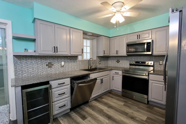 3961 Painter Branch Rd, Crestview, FL 32539 - kitchen with appliances with stainless steel finishes, wine cooler, a sink, a ceiling fan, and dark wood finished floors
