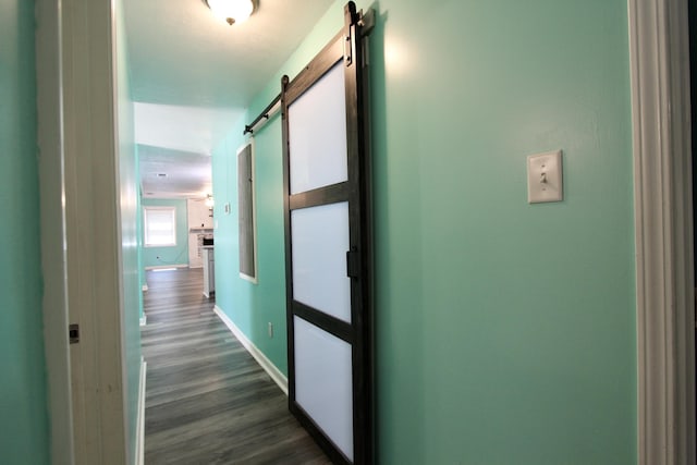 3961 Painter Branch Rd, Crestview, FL 32539 - hall with a barn door, dark wood-style floors, and baseboards