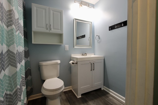 3961 Painter Branch Rd, Crestview, FL 32539 - bathroom featuring wood finished floors, toilet, vanity, baseboards, and a shower with shower curtain
