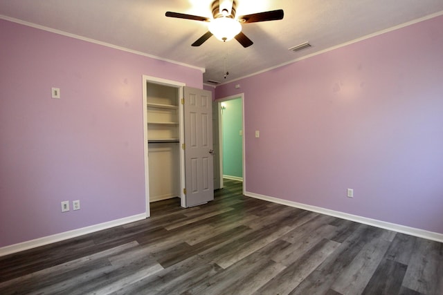 3961 Painter Branch Rd, Crestview, FL 32539 - unfurnished bedroom with dark wood-type flooring, baseboards, a closet, and crown molding