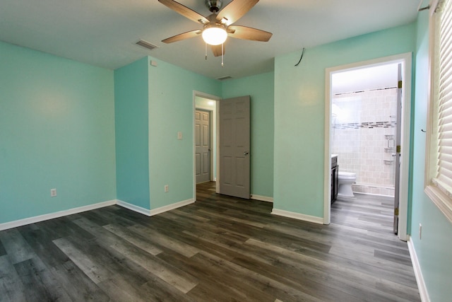 3961 Painter Branch Rd, Crestview, FL 32539 - unfurnished bedroom with dark wood-type flooring, baseboards, ensuite bath, and ceiling fan