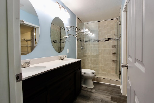 3961 Painter Branch Rd, Crestview, FL 32539 - bathroom with a stall shower, wood finished floors, toilet, and double vanity