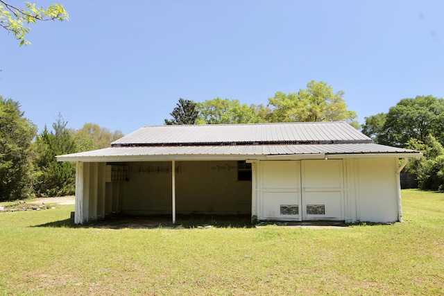 3961 Painter Branch Rd, Crestview, FL 32539 - back of house featuring a lawn, metal roof, and a carport