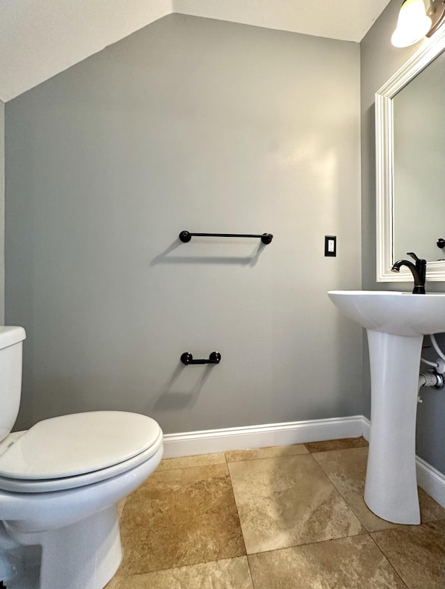 305 Mattie M Kelly Blvd, Destin, FL 32541 - half bathroom featuring toilet, baseboards, and vaulted ceiling