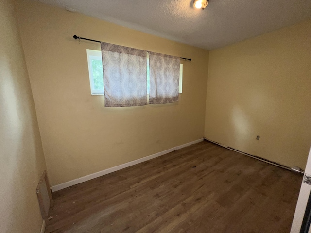 123 Panama Dr, Crestview, FL 32536 - unfurnished room with wood finished floors, baseboards, and a textured ceiling