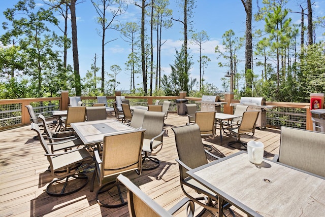 wooden deck featuring outdoor dining area and area for grilling